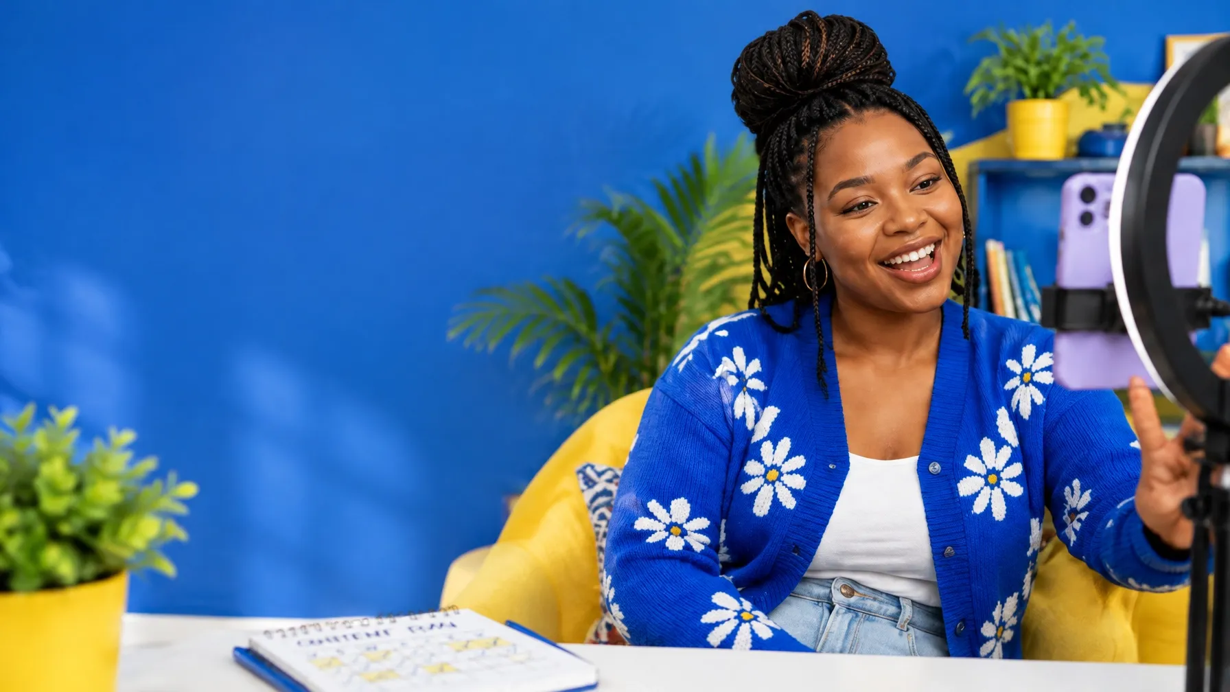 Akhona smiling while creating content in her bright blue studio